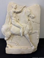 Front view of entire relief sculpture showing figure and horse