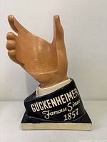 Front view of Guckenheimer hand bottle holder showing raised lettering and overall condition