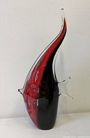 Full view right side of red and black glass fish sculpture