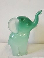 Front left profile of green alabastro glass elephant figurine
