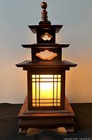 Front view of illuminated wood and glass pagoda lamp