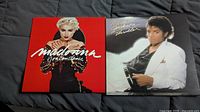 Front covers of both LPs: Madonna in red, Michael Jackson in white suit.