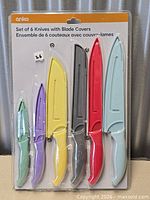 Front view of sealed retail package displaying six coloured knives with blade covers