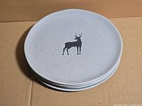 Stack of four deer motif plates top view