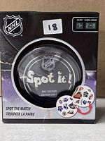 Front view of sealed Spot It! NHL Edition box showing tin