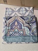 Folded patterned shower curtain front view