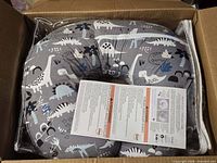 Pillow inside box, plastic-wrapped with instruction leaflet visible