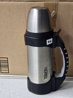 Full view of Thermos stainless bottle with handle