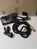 Entire lot showing hose, nozzle, wall mount, storage bag