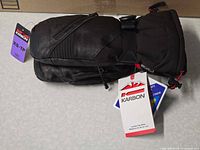 Pair of black leather Karbon ski mitts with tags visible