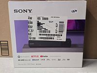 Front of retail box with product image and shipping label