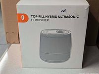 Front of retail box showing TaoTronics top fill hybrid ultrasonic humidifier
