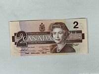 Obverse of 1986 Canadian $2 note showing portrait, denomination, signatures