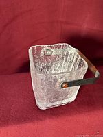 Front view of square textured glass ice bucket showing handle attachment