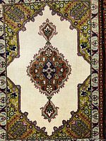 Close-up of medallion and border on ivory field