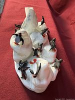 Top view of handmade glass sculpture showing penguins and seals on white glass base