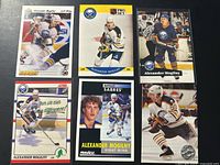 Group shot of six Alexander Mogilny hockey cards and coin