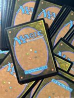Stack of card backs showing Magic: The Gathering logo