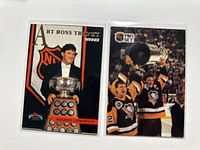 Fronts of both cards in sleeves—Art Ross Trophy and Stanley Cup images