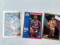 All three sleeved cards side by side: Drexler Topps, Mutombo Fleer, Stockton SkyBox