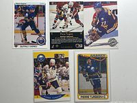 Five Pierre Turgeon hockey cards laid out including one reverse side