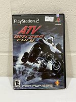 Front of PS2 case showing title, ESRB rating E, Not For Sale marking