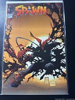 Front cover of Spawn #32 comic book in protective sleeve