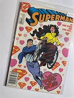 Front cover showing Superman Issue 12 bagged in polybag