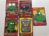 Five Trash Pack cards laid out showing fronts and artwork