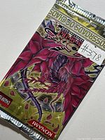 Front view of sealed Yu-Gi-Oh! Crossroads of Chaos booster pack, artwork and seal visible