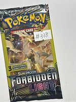 Front view of sealed Pokémon Sun & Moon Forbidden Light booster pack