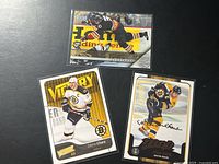 Three Zdeno Chara cards laid out; two Bruins, one Senators