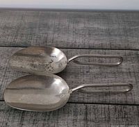 Two metal Skyline scoops showing overall form and handles