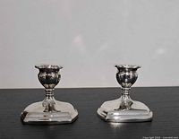 Front view of both matching Viking Plate silverplate candlesticks