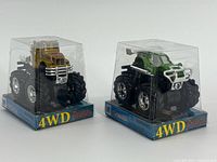 Front view of both sealed mini monster trucks showing 4WD Friction branding