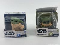 Front view of both boxed Grogu figures, Series 2 and Series 3