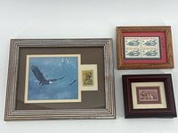 Three framed stamp displays: Bald Eagle print with stamp, Law and Order six-stamp block, Teachers of America three-stamp block