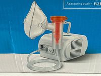 marketing image of vaporizer compressor with mask, tube, cup