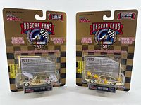 Front view of both packaged gold die-cast cars
