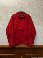 Front view of red Chaps jacket hanging