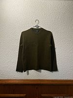 Sweater front view hanging on hanger