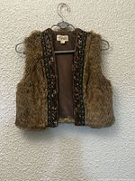 Front view of brown faux fur Boutique XXI vest on hanger