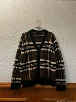 Front view of Le 31 plaid cardigan on hanger