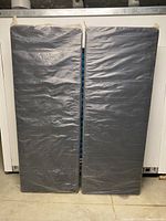 Both foundation pieces standing side by side, showing factory wrap