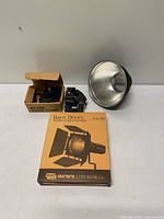 Boxed Aurora Lite Bank ALR018 barn doors, two Art.035 super clamps, metal reflector dish