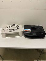 Both printers side by side on table showing overall condition