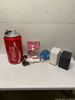 All items grouped on table: cooler, fans, dryer, extension cord, two modems