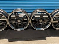 Front view of three wheels showing spoke pattern and center caps