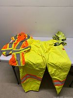 All three hi-vis workwear items laid out on table