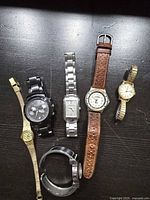 All six watches laid out on table